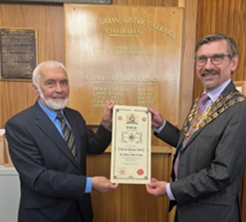 Photo of The Mayor of Biddulph, Jim Garvey, presenting Tony Hall, retiring Councillor with the Honorary Freeman Scroll
